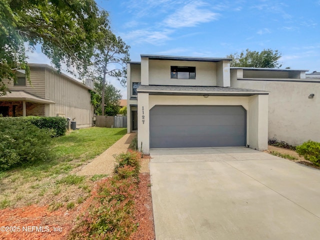 1127 Romaine Cir W, Jacksonville, FL 32225 - view of front of property featuring stucco siding, an attached garage, concrete driveway, and central AC unit