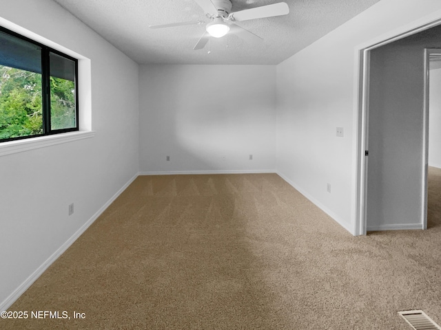 1127 Romaine Cir W, Jacksonville, FL 32225 - carpeted spare room featuring ceiling fan, a textured ceiling, and baseboards