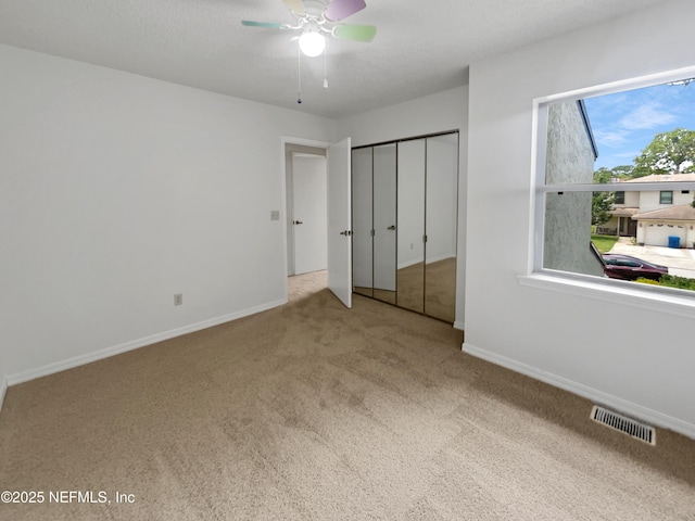 1127 Romaine Cir W, Jacksonville, FL 32225 - unfurnished bedroom with carpet flooring, baseboards, a closet, and a ceiling fan