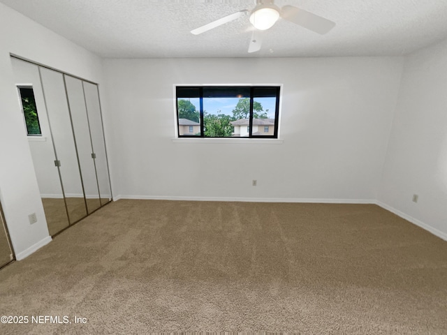 1127 Romaine Cir W, Jacksonville, FL 32225 - unfurnished bedroom with carpet floors, baseboards, a closet, a textured ceiling, and a ceiling fan