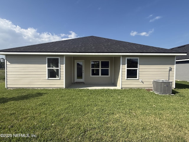 8322 Helmsley Blvd, Jacksonville, FL 32219 - back of property featuring central air condition unit, a patio, a lawn, and roof with shingles