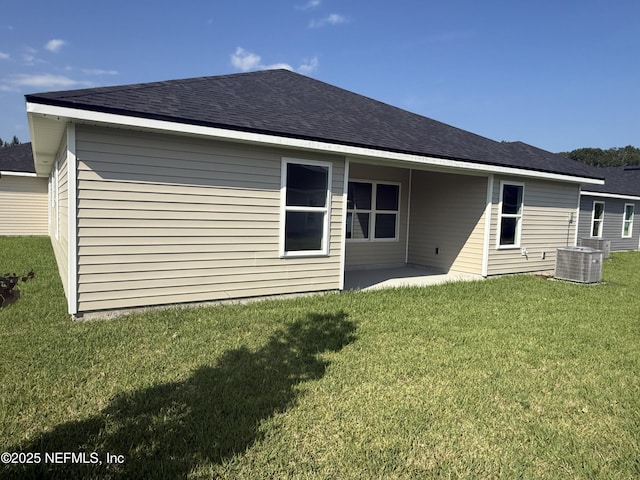 8322 Helmsley Blvd, Jacksonville, FL 32219 - rear view of house featuring central AC, a yard, a patio area, and a shingled roof