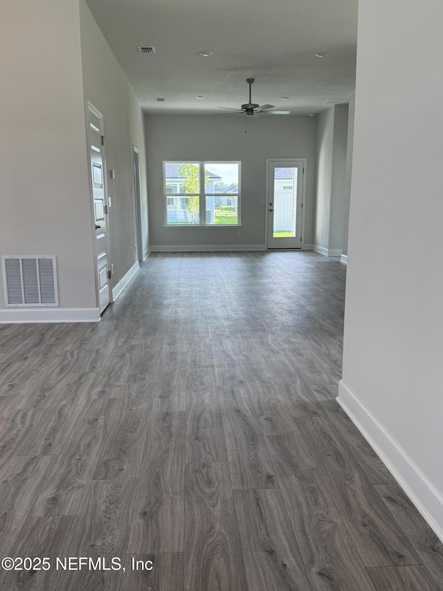 8322 Helmsley Blvd, Jacksonville, FL 32219 - unfurnished room featuring dark wood-style flooring, ceiling fan, and baseboards