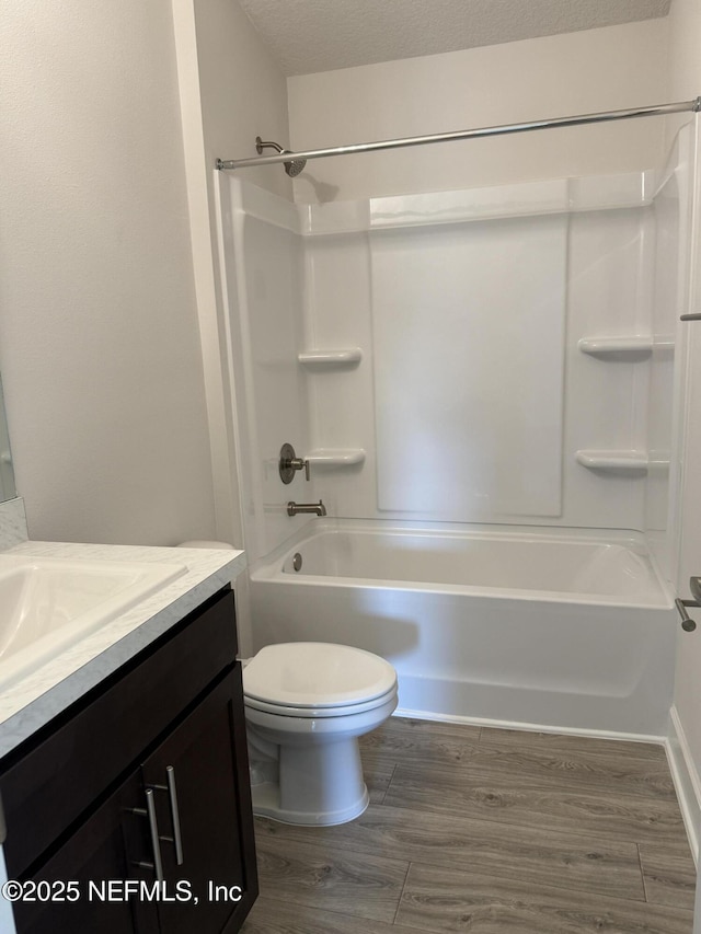 8322 Helmsley Blvd, Jacksonville, FL 32219 - full bath with vanity, wood finished floors, shower / washtub combination, toilet, and a textured ceiling