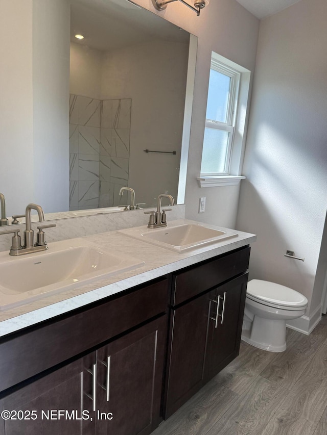 8322 Helmsley Blvd, Jacksonville, FL 32219 - full bathroom featuring double vanity, wood finished floors, toilet, and a shower
