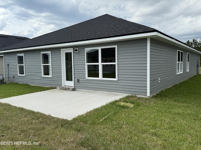 8316 Helmsley Blvd, Jacksonville, FL 32219 - rear view of property with a yard, a patio, and a shingled roof