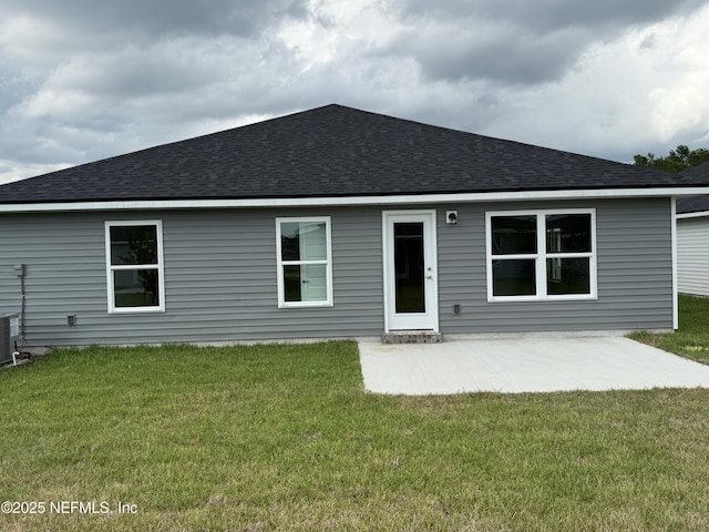 8316 Helmsley Blvd, Jacksonville, FL 32219 - rear view of property featuring roof with shingles, a lawn, and a patio area