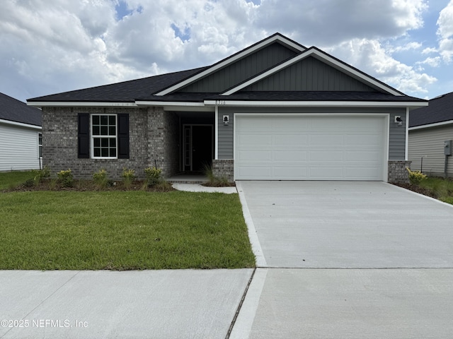 8316 Helmsley Blvd, Jacksonville, FL 32219 - view of front of home with driveway, a front yard, an attached garage, and brick siding