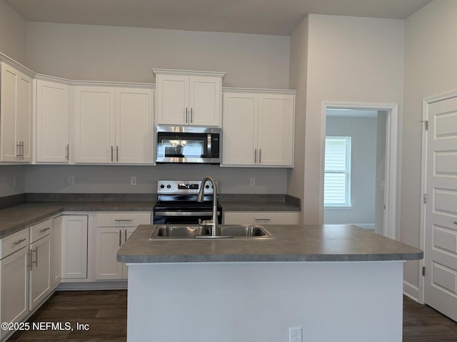 8316 Helmsley Blvd, Jacksonville, FL 32219 - kitchen with appliances with stainless steel finishes, a sink, dark wood-type flooring, white cabinetry, and a kitchen island with sink