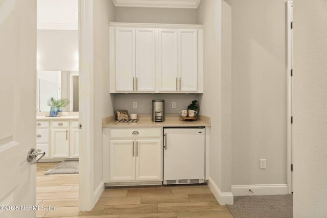 228 Waterline Dr, Saint Johns, FL 32259 - bar area featuring refrigerator, light wood-style floors, crown molding, and baseboards