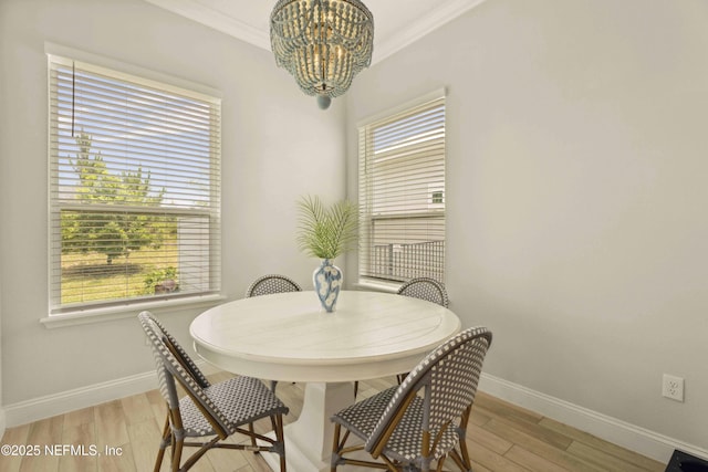 228 Waterline Dr, Saint Johns, FL 32259 - dining space with baseboards, a chandelier, crown molding, and light wood-style floors