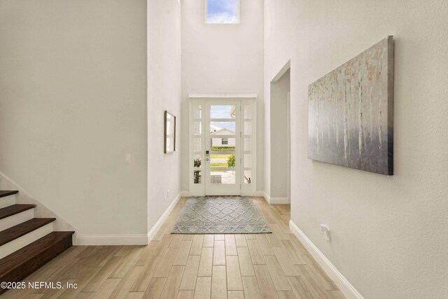 228 Waterline Dr, Saint Johns, FL 32259 - foyer with wood finished floors, baseboards, a high ceiling, and stairs