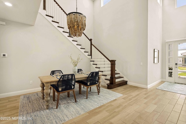 228 Waterline Dr, Saint Johns, FL 32259 - entryway with a towering ceiling, stairs, baseboards, light wood-style flooring, and a chandelier