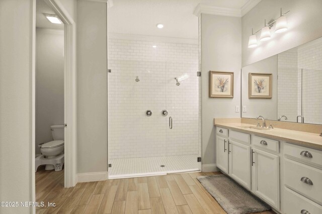 228 Waterline Dr, Saint Johns, FL 32259 - bathroom featuring wood finished floors, vanity, a shower stall, toilet, and crown molding