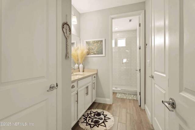 228 Waterline Dr, Saint Johns, FL 32259 - bathroom with a shower stall, vanity, wood finished floors, and baseboards