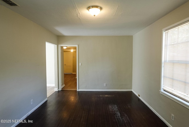 3763 Valley Rd, Jacksonville, FL 32207 - empty room featuring dark wood-style flooring, baseboards, and healthy amount of natural light