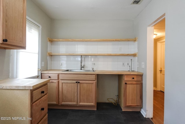 3763 Valley Rd, Jacksonville, FL 32207 - kitchen featuring open shelves, a sink, decorative backsplash, and light countertops