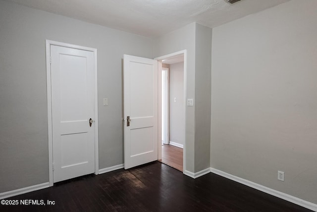 3763 Valley Rd, Jacksonville, FL 32207 - unfurnished bedroom featuring dark wood finished floors and baseboards