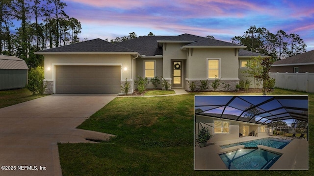 90 Lancelot Dr, Palm Coast, FL 32137 - view of front of home with stucco siding, stone siding, an attached garage, concrete driveway, and a pool with connected hot tub
