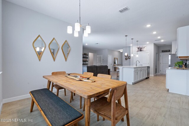 90 Lancelot Dr, Palm Coast, FL 32137 - dining room with baseboards, recessed lighting, and a chandelier