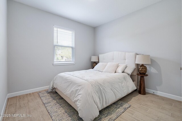 90 Lancelot Dr, Palm Coast, FL 32137 - bedroom with light wood-style floors and baseboards