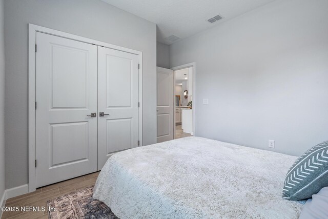 90 Lancelot Dr, Palm Coast, FL 32137 - bedroom featuring wood finished floors, a closet, and baseboards