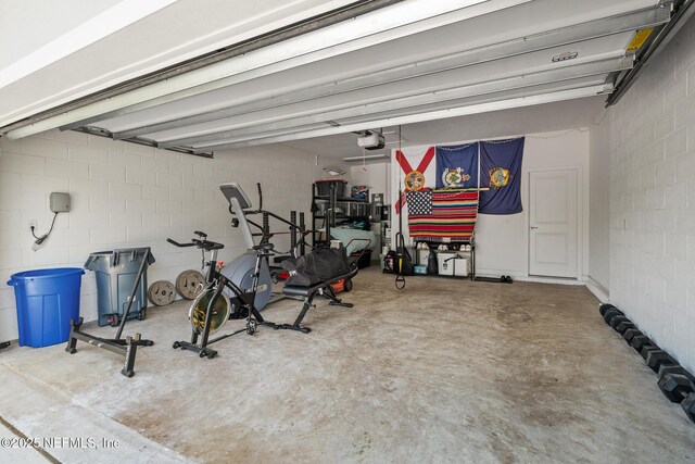 90 Lancelot Dr, Palm Coast, FL 32137 - garage with a garage door opener and concrete block wall