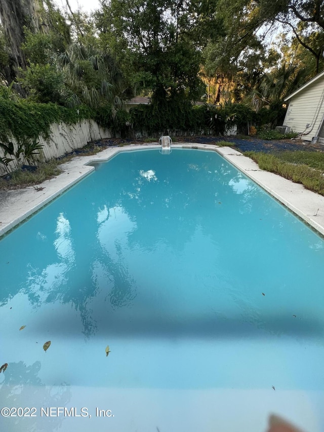 5715 Wiltshire St, Jacksonville, FL 32211 - view of pool with view of wooded area and a fenced backyard