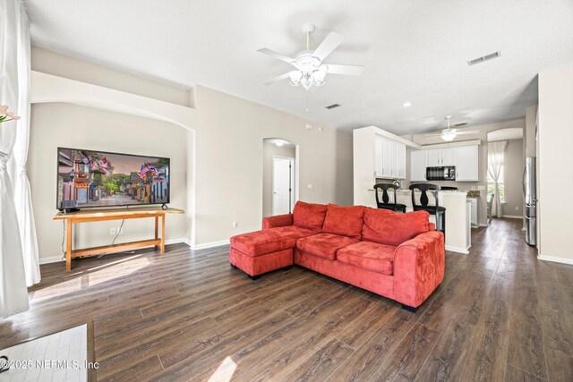 528 Sparrow Branch Cir, Saint Johns, FL 32259 - living room with a ceiling fan, dark wood finished floors, arched walkways, and baseboards