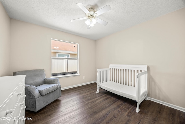528 Sparrow Branch Cir, Saint Johns, FL 32259 - bedroom with wood finished floors, a textured ceiling, baseboards, a ceiling fan, and a nursery area