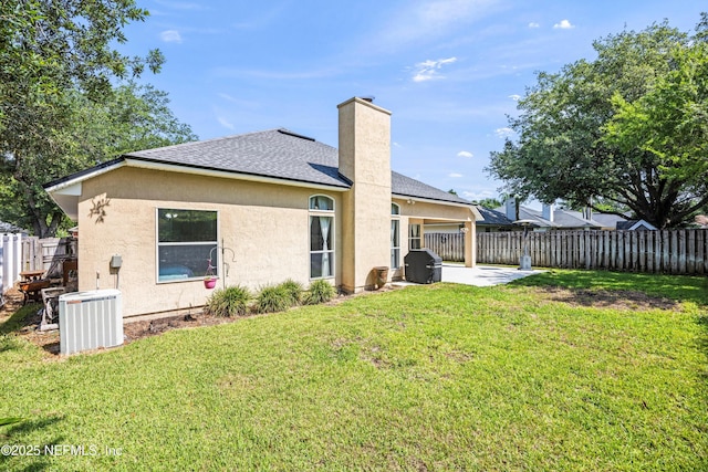 528 Sparrow Branch Cir, Saint Johns, FL 32259 - rear view of house with stucco siding, roof with shingles, a patio area, central air condition unit, and a chimney