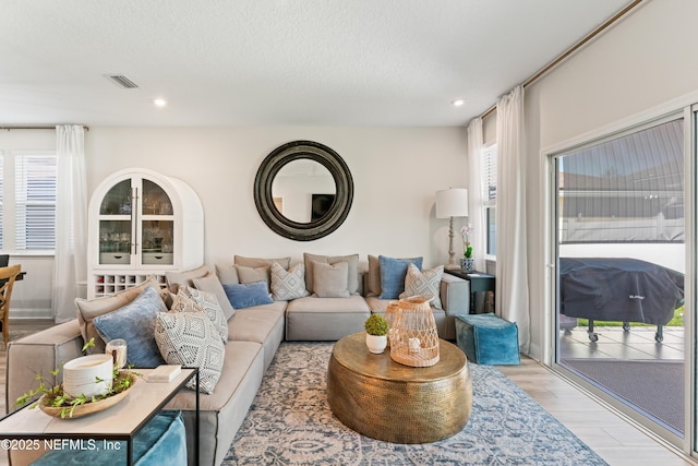 571 Meadow Creek Dr, Saint Johns, FL 32259 - living area featuring light wood finished floors, recessed lighting, and a textured ceiling