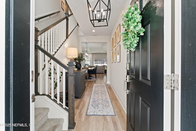 571 Meadow Creek Dr, Saint Johns, FL 32259 - foyer entrance with light wood-type flooring, stairway, a chandelier, and baseboards