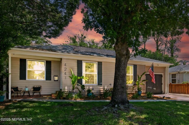 4241 Lexington Ave, Jacksonville, FL 32210 - view of front of property featuring a lawn, a garage, and covered porch