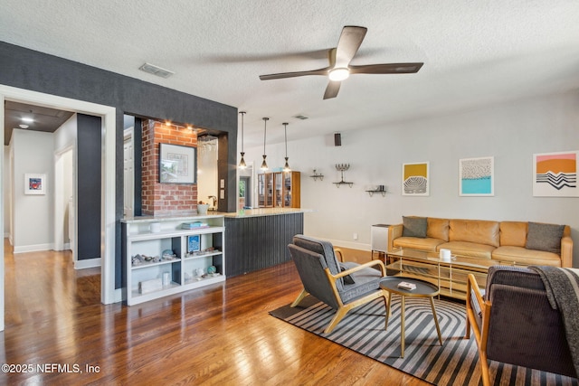 4241 Lexington Ave, Jacksonville, FL 32210 - living area with wood finished floors, ceiling fan, a textured ceiling, and baseboards