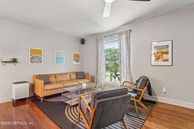 4241 Lexington Ave, Jacksonville, FL 32210 - living area with wood finished floors, a ceiling fan, baseboards, and a textured ceiling