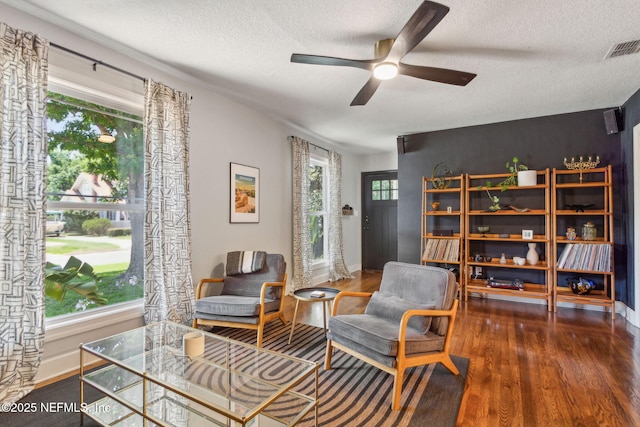 4241 Lexington Ave, Jacksonville, FL 32210 - living area featuring wood finished floors, a textured ceiling, ceiling fan, and baseboards