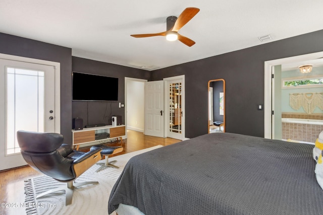 4241 Lexington Ave, Jacksonville, FL 32210 - bedroom featuring wood finished floors, connected bathroom, and ceiling fan