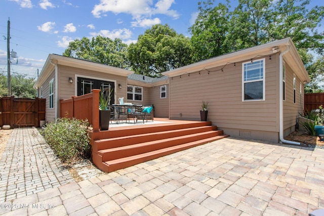 4241 Lexington Ave, Jacksonville, FL 32210 - rear view of house featuring a gate, a patio area, outdoor dining area, and a deck