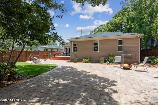 4241 Lexington Ave, Jacksonville, FL 32210 - back of property featuring a deck, an outdoor fire pit, a patio, and central air condition unit