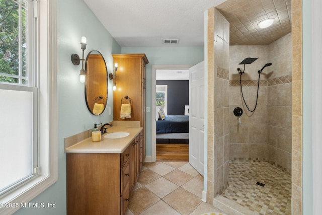 4241 Lexington Ave, Jacksonville, FL 32210 - bathroom featuring vanity, tiled shower, ensuite bathroom, and tile patterned floors