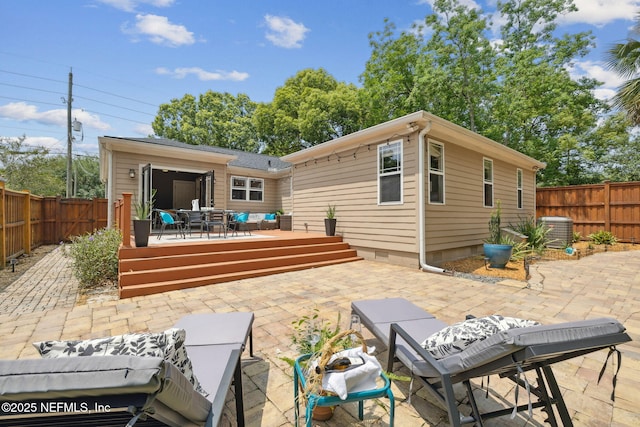 4241 Lexington Ave, Jacksonville, FL 32210 - rear view of house featuring a wooden deck, outdoor dining area, a fenced backyard, and a patio area