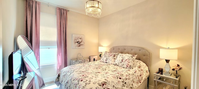 55 Fairlake Cir, Saint Augustine, FL 32092 - bedroom featuring a chandelier and wood finished floors
