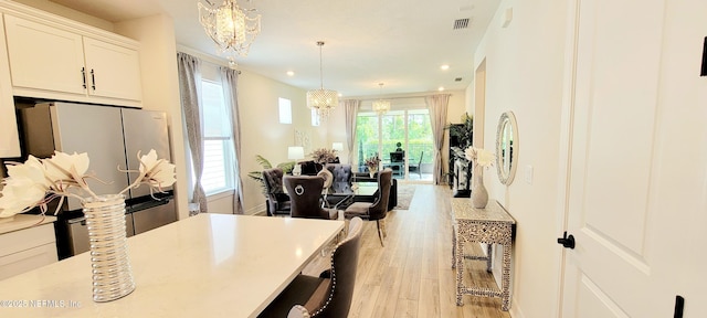 55 Fairlake Cir, Saint Augustine, FL 32092 - kitchen featuring a chandelier, light wood-style floors, recessed lighting, freestanding refrigerator, and hanging light fixtures