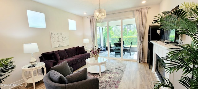 55 Fairlake Cir, Saint Augustine, FL 32092 - living room with light wood-type flooring, a chandelier, recessed lighting, a fireplace, and baseboards