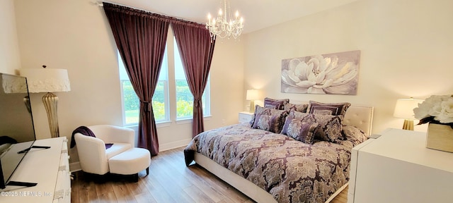 55 Fairlake Cir, Saint Augustine, FL 32092 - bedroom featuring a chandelier, light wood finished floors, and baseboards