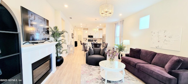 55 Fairlake Cir, Saint Augustine, FL 32092 - living area featuring a chandelier, light wood-type flooring, recessed lighting, and a glass covered fireplace