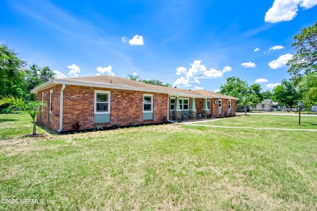 2155 Diana Dr, Palatka, FL 32177 - rear view of house featuring a yard and brick siding