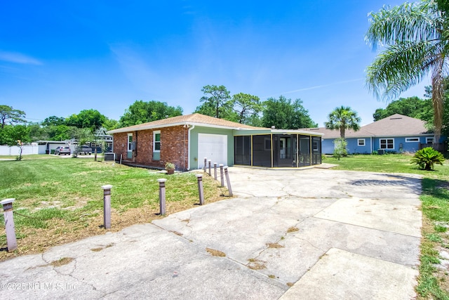 2155 Diana Dr, Palatka, FL 32177 - view of front of property with a sunroom, an attached garage, driveway, and a front lawn
