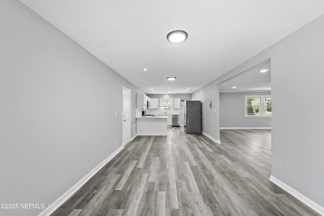 2155 Diana Dr, Palatka, FL 32177 - unfurnished living room featuring baseboards, wood finished floors, and recessed lighting